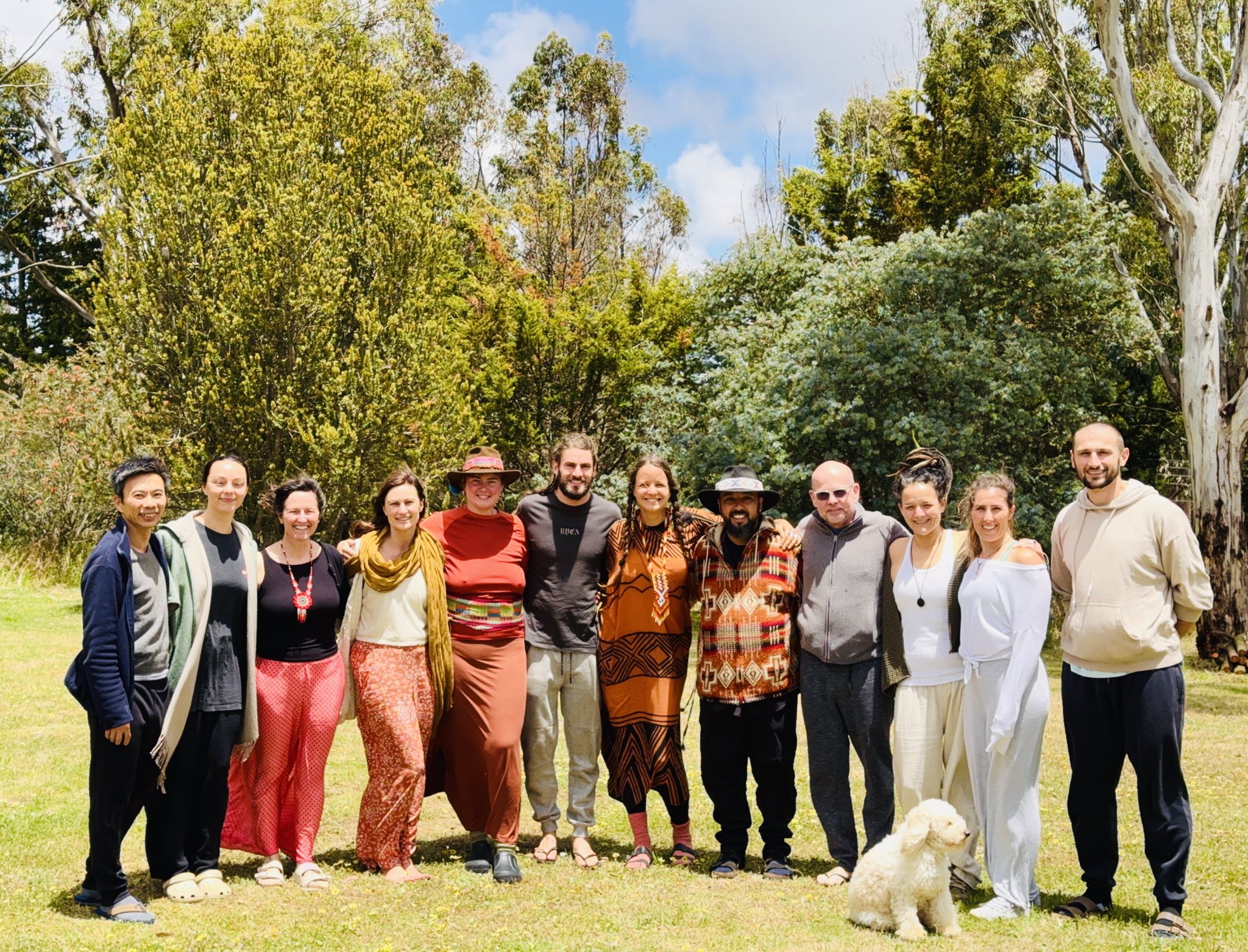 A group gathered together in a sunlit garden.